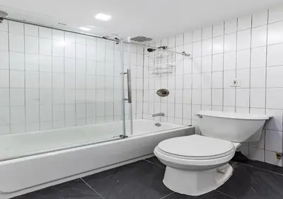 a bathroom with a toilet and a bath tub at Cozy Studio! Steps to Central Park & Upper E Side!, June To Aug 90 Days Stay Required in New York