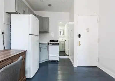 a kitchen with white appliances and a white refrigerator at Cozy Studio! Steps to Central Park & Upper E Side!, June To Aug 90 Days Stay Required in New York