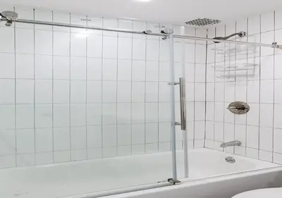 a white bathroom with a tub and a toilet at Cozy Studio! Steps to Central Park & Upper E Side!, June To Aug 90 Days Stay Required in New York