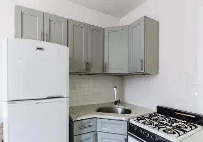 a kitchen with a white refrigerator and a sink at Cozy Studio! Steps to Central Park & Upper E Side!, June To Aug 90 Days Stay Required in New York