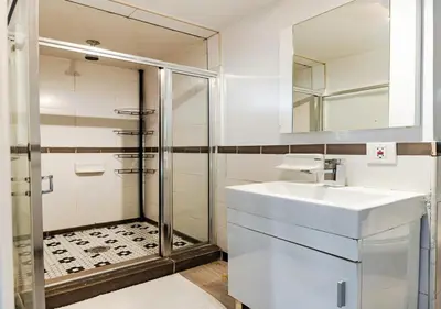 a bathroom with a sink and a shower at Spacious Upper East Side Studio, June To Aug 90 Days Stay Required in New York