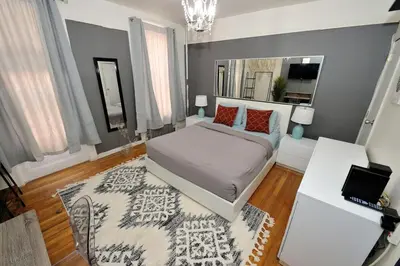 a bedroom with a bed and a rug at Furnished 2 Bedroom Apartment in Lennox Hill, June To Aug 90 Days Stay Required in New York