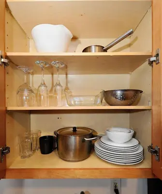 a cabinet filled with dishes and bowls and plates at Furnished 2 Bedroom Apartment in Lennox Hill, June To Aug 90 Days Stay Required in New York