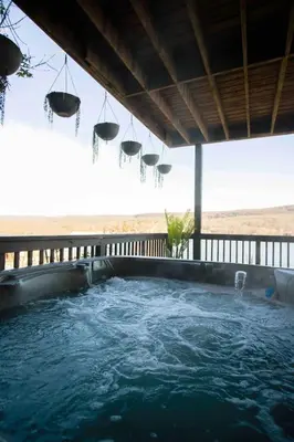 a large plunge pool with hanging baskets and water at Lakeview Villa with Private Hot Tub, Firepit & Breathtaking Cliff Views in Greenwood Lake