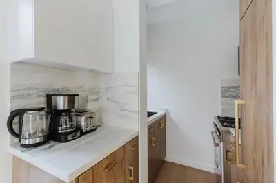a kitchen with a coffee maker on a counter at Blueground Midtown E wd doorman nr E River NYC-1527 in New York