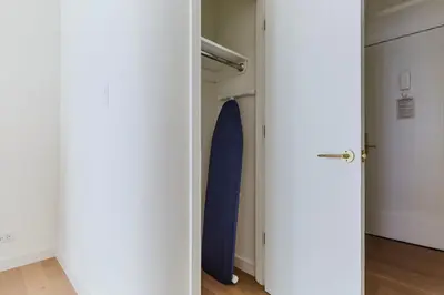 a room with a closet with a blue surfboard at Blueground Midtown E wd doorman nr E River NYC-1527 in New York