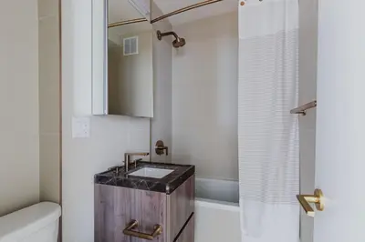 a small bathroom with a sink and a tub at Blueground Midtown E wd doorman nr E River NYC-1527 in New York