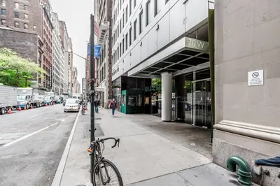 a bike parked on a sidewalk next to a street at Blueground Midtown S gym roof nr Times Sq NYC-1776 in New York