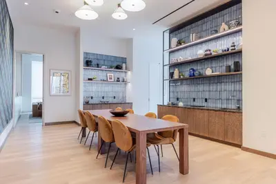 a dining room with a wooden table and chairs at Blueground LIC gym wd nr MoMA PS1 NYC-1796 in New York