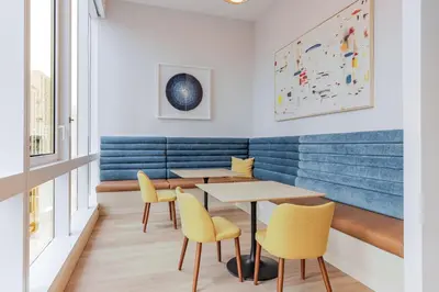 a dining room with two tables and yellow chairs at Blueground LIC gym wd nr MoMA PS1 NYC-1796 in New York