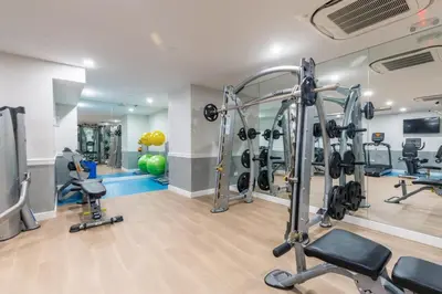 a gym with treadmills and weights in a room at UWS 2br w wd doorman gym nr Central Park NYC-1082 in New York