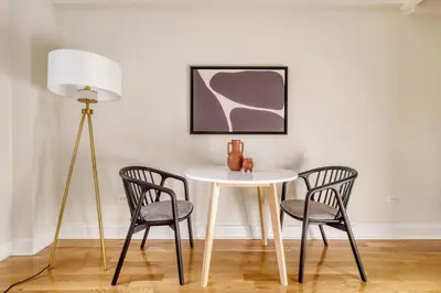 a table and two chairs and a lamp in a room at UWS 2br w wd doorman gym nr Central Park NYC-1082 in New York