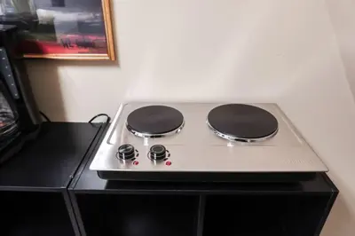a stove top oven sitting on top of a counter at Cozy Attic Studio for 2 5min to NYC Train Station in West Orange