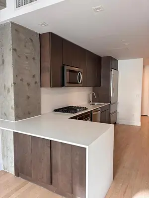 a kitchen with a white counter top and wooden cabinets at Best Location in Greenwich Village in New York