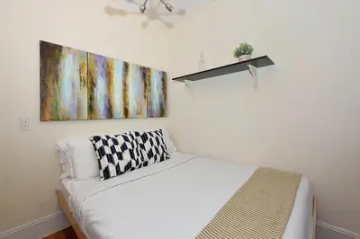 a room with a couch and a painting on the wall at Midtown West 3 Bedroom Washer dryer and Dishwasher, June to Aug 90 days stay required in New York