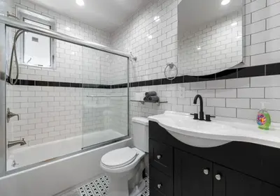 a white bathroom with a sink and a toilet and a tub at Amazing Location Murray Hill 3 Bedroom Apartment ,June to Aug 90 days stay required in New York