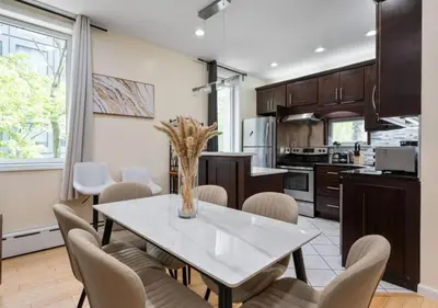 a kitchen with a dining room table and chairs at Amazing Location Murray Hill 3 Bedroom Apartment ,June to Aug 90 days stay required in New York