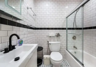 a bathroom with a toilet and a sink and a shower at Amazing Location Murray Hill 3 Bedroom Apartment ,June to Aug 90 days stay required in New York