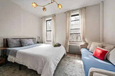 a bedroom with a bed and a couch at Cozy 2BR in NYC! Lenox Hill!, June to Aug 90 days stay required in New York