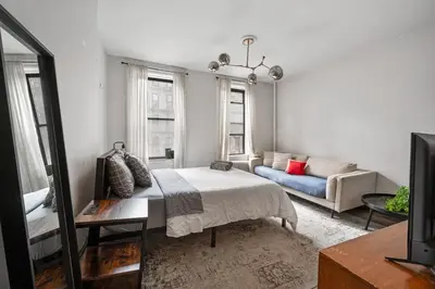 a living room with a bed and a couch at Cozy 2BR in NYC! Lenox Hill!, June to Aug 90 days stay required in New York