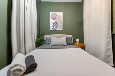 a bedroom with a white bed and a green wall at Cozy 2BR in NYC! Lenox Hill!, June to Aug 90 days stay required in New York