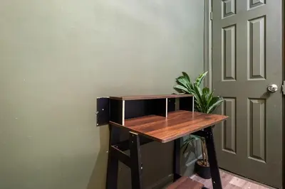 a wooden table next to a door with a plant at Cozy 2BR in NYC! Lenox Hill!, June to Aug 90 days stay required in New York