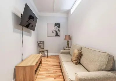 a living room with a couch and a table at Chelsea 2BR Gem! in New York