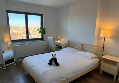 a panda bear sitting on a bed in a bedroom at Newly Reno 1BR! Murray Hill! in New York