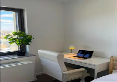 a desk with a laptop and a chair next to a window at Newly Reno 1BR! Murray Hill! in New York