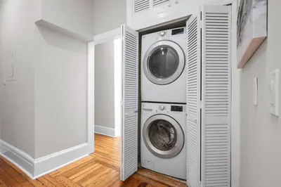 a laundry room with a washer and dryer at Luxury Townhouse in NYC in New York