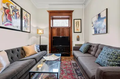 a living room with a couch and a table at Luxury Townhouse in NYC in New York