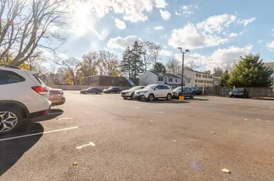 a parking lot with several cars parked in it at Westville Stay 2BR Near Yale in New Haven