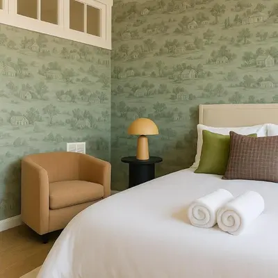 a bedroom with a bed and a chair at Westville Stay 2BR Near Yale in New Haven