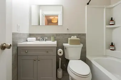 a bathroom with a toilet and a sink and a tub at Westville Stay 2BR Near Yale in New Haven