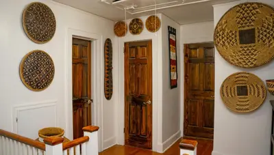 a hallway with wooden doors and plates on the wall at African Oasis Luxury Inn at the Gallery in Mount Vernon