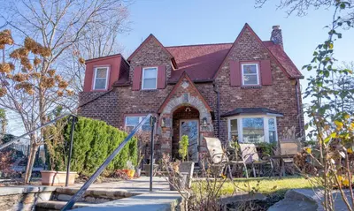 a brick house with chairs in front of it at African Oasis Luxury Inn at the Gallery in Mount Vernon
