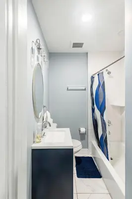 a bathroom with a sink and a mirror at Prime Location Explore NYC in West New York