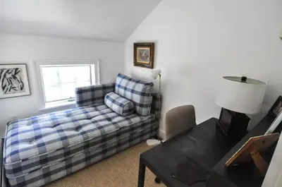 a living room with a couch and a table at Haddock Cotter Chic Farmhouse and Barn w Pool in Old Chatham