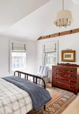 a bedroom with a bed and a dresser and windows at Haddock Cotter Chic Farmhouse and Barn w Pool in Old Chatham