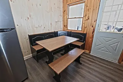 a wooden table and benches in a room with a door at Private Hot tub new 2 Bedroom Home in Catskills in Elka Park