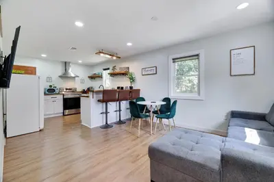 a living room and kitchen with a couch and a table at Cozy 2 Bedroom apartment in Tannersville, minutes from Camelback Mountain in Tannersville