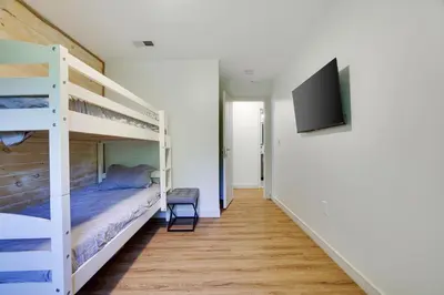 a bedroom with two bunk beds and a flat screen tv at Cozy 2 Bedroom apartment in Tannersville, minutes from Camelback Mountain in Tannersville