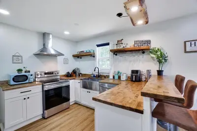 a kitchen with white cabinets and wooden counter tops at Cozy 2 Bedroom apartment in Tannersville, minutes from Camelback Mountain in Tannersville