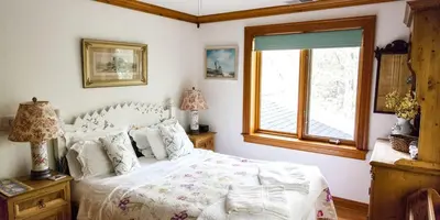 a bedroom with a white bed and a window at Country Getaway Nestled in Enchanting Westchester County near New York City in Bedford
