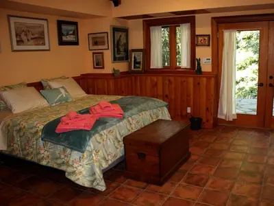 a bedroom with a bed with a red robe on it at Lovely Accommodation Surrounded by Stunning Forests in Bedford near New York City in Bedford