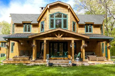 a log home with a large front porch at Lovely Accommodation Surrounded by Stunning Forests in Bedford near New York City in Bedford