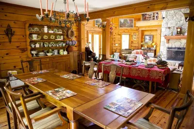 a dining room with wooden walls and a table and chairs at Lovely Accommodation Surrounded by Stunning Forests in Bedford near New York City in Bedford