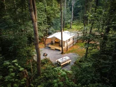 an overhead view of a tent in a forest at Gorgeous Safari Tent in the Lake George Area of the Adirondack Mountains, Perfect for a Family Weekend Away in Corinth