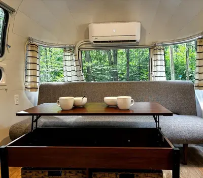 a table with three cups on top of a couch at Waterfront, Pet Friendly Airstream near Lake George in the Adirondack, New York in Corinth