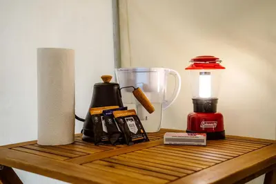 a counter with a blender on a table with a lamp at Luxury Group Safari Tent Complete with Firepit and Patio, Perfect for a Weekend Escape to the Adirondacks in Corinth